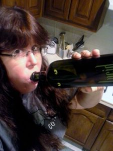 Image of Nicola Cameron drinking heartily from a bottle of Lucid Absinthe Supérieure